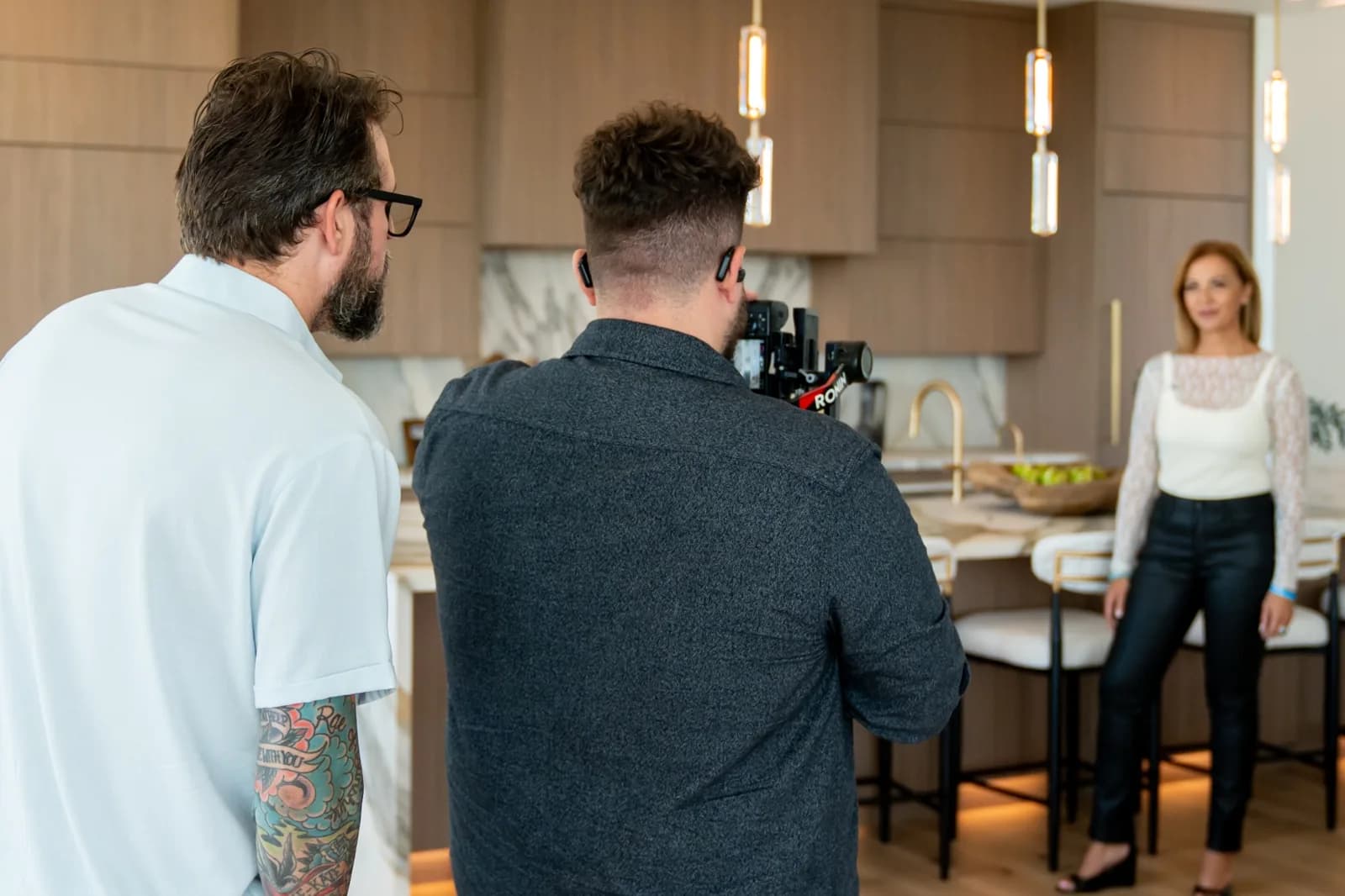 A BReal camera crew filming Rebecca in a white blouse